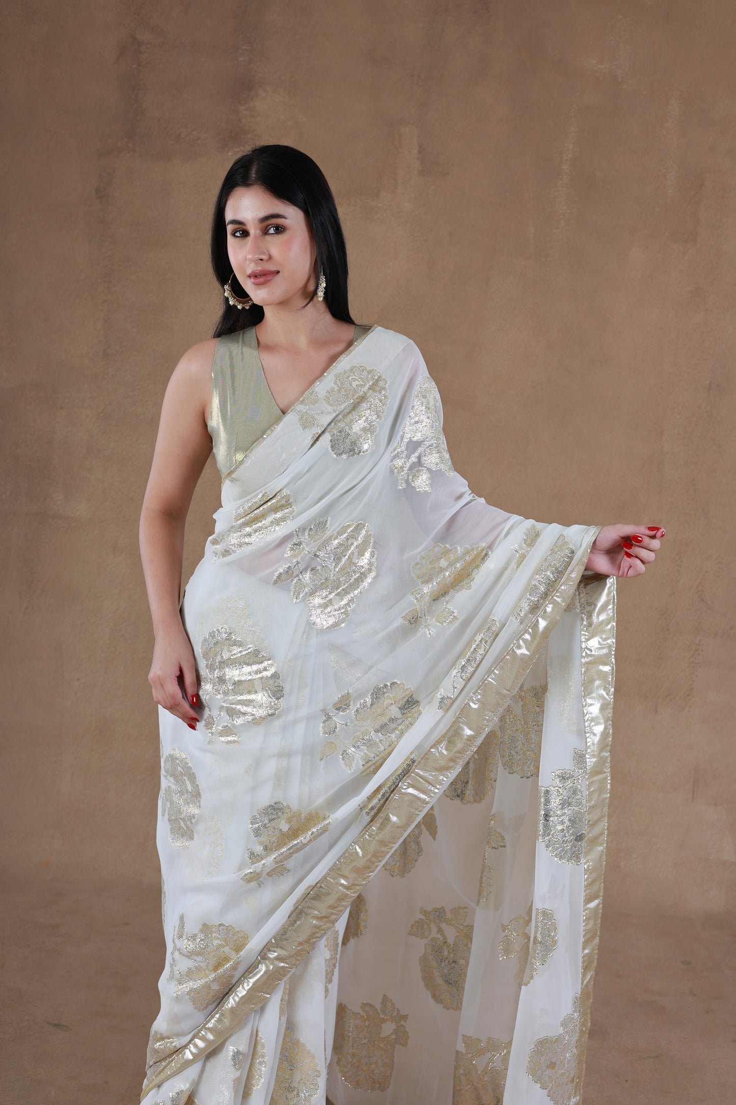 Model in Slay Official Aurora Gold Foil Saree designed by Simar, showcasing a front pose with left hand lifted.