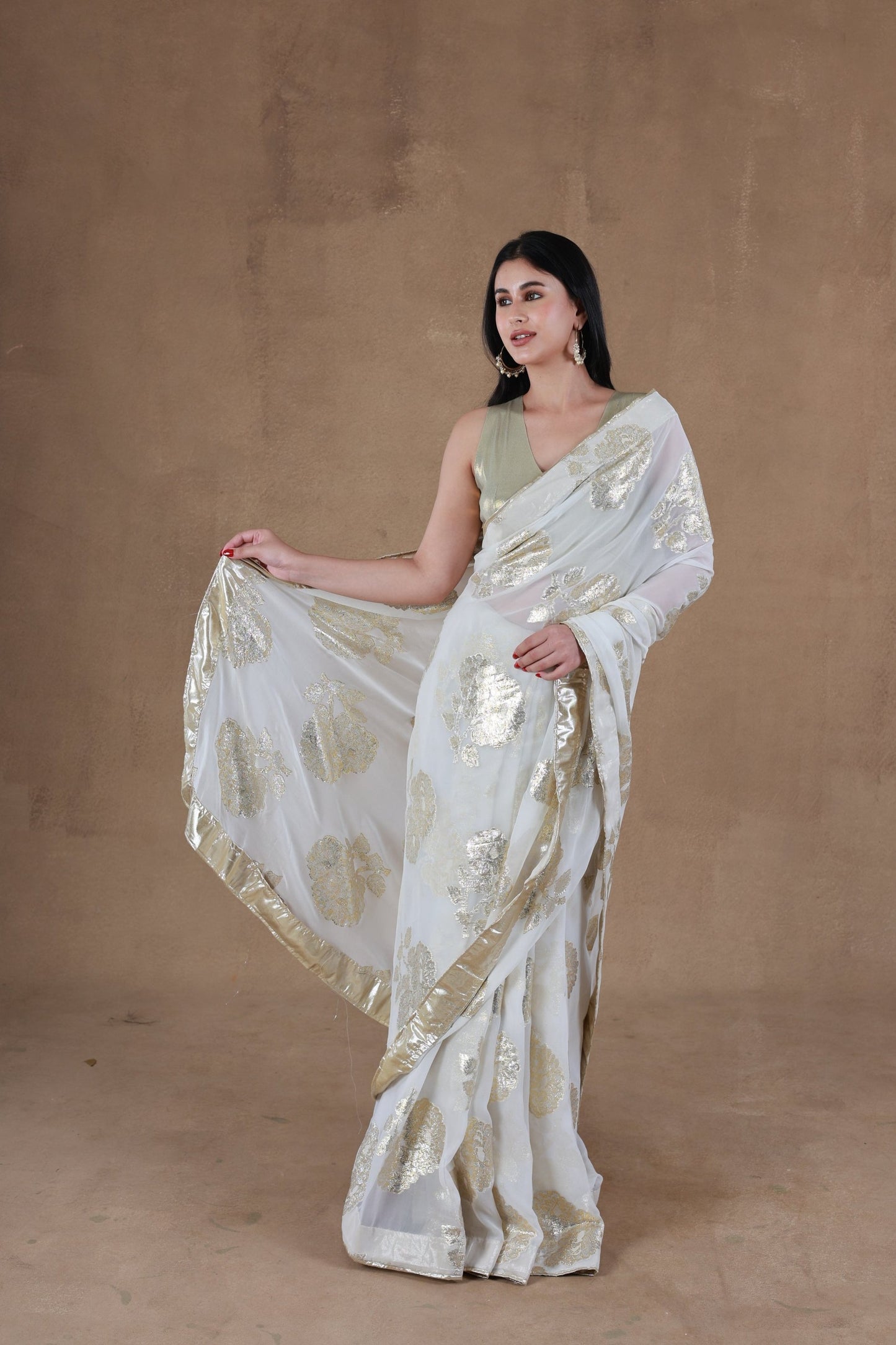 Model in Slay Official Aurora Gold Foil Saree designed by Simar, showcasing a front pose with right hand lifted.